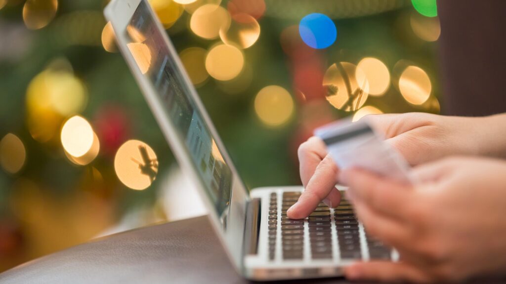 Stock image of a woman shopping online with credit card