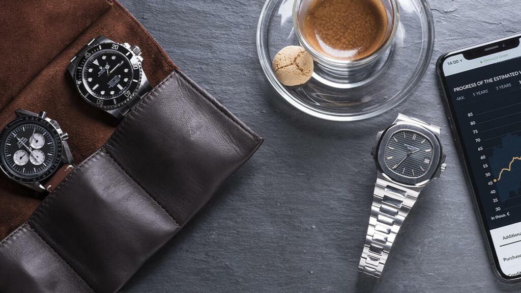 Watches on a table next to a coffee cup