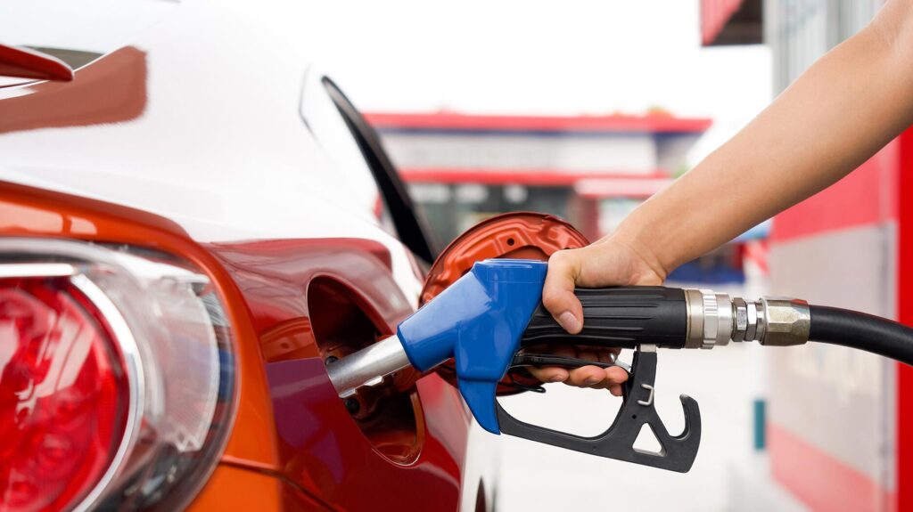 Hand putting gas pump in car